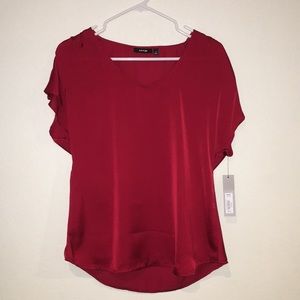 Maroon silk blouse.